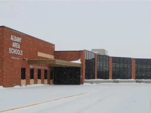 A large brick building with a parking garage.